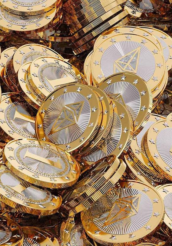 A close-up image of a pile of gold coins, featuring intricate designs and a shiny finish.